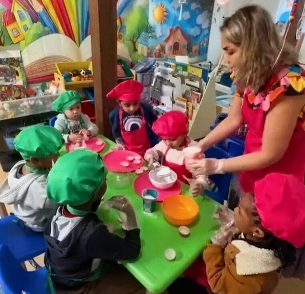 Children participating in a cooking activity at Aria Daycare